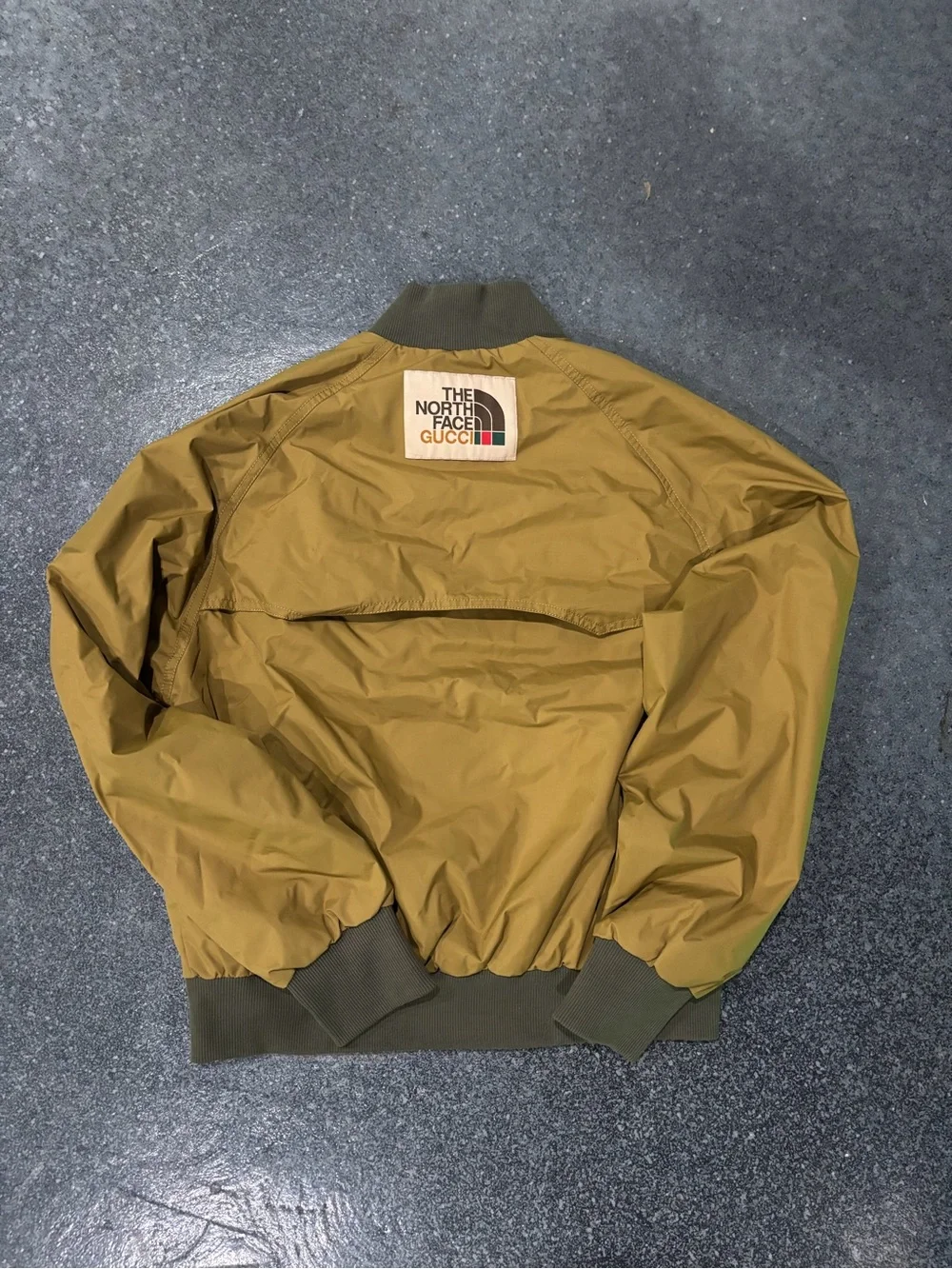 The North Face Olive Green Bomber Jacket with Logo Patch with garment bag & box